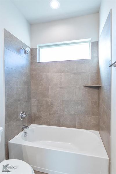 Full bathroom featuring shower / tub combination and recessed lighting