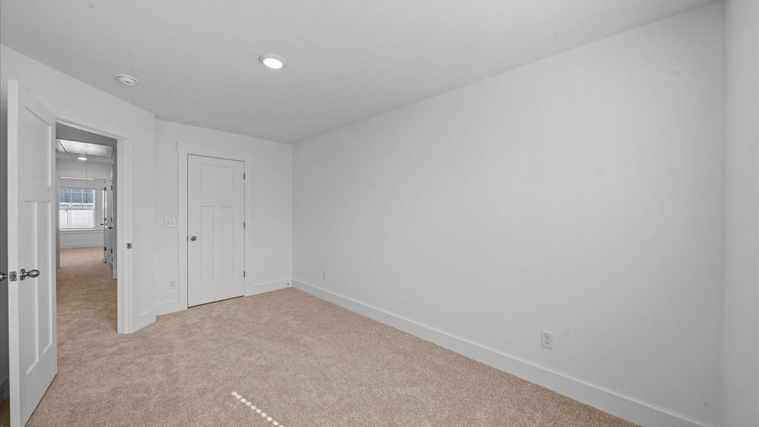 Superior comfort in this light-filled bedroom with plush carpeting and thoughtfully placed large windows Superior comfort in this light-filled bedroom with plush carpeting and thoughtfully placed large windows