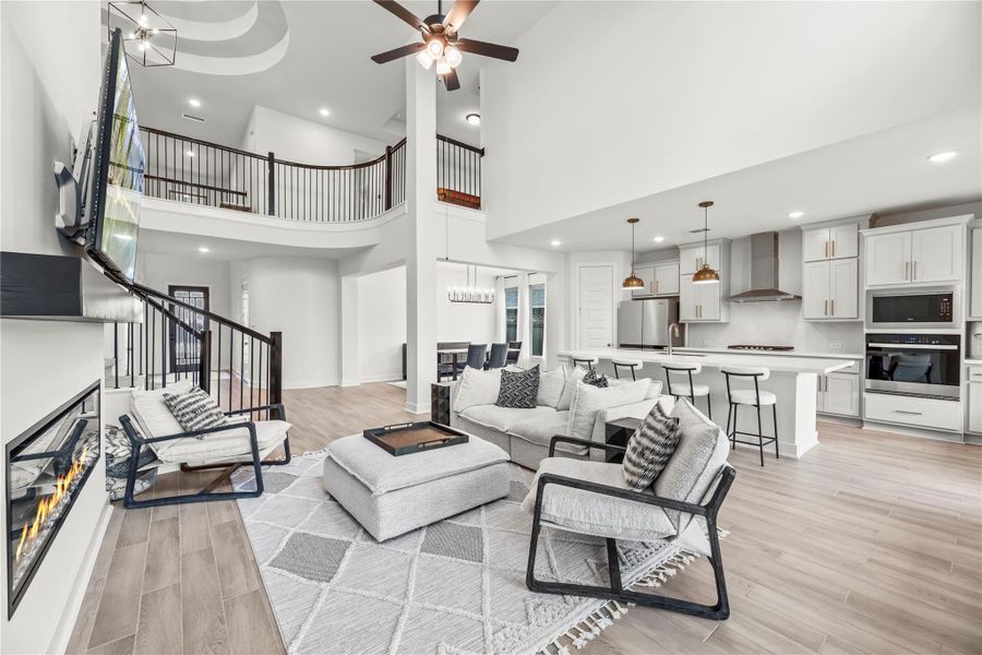 Impressive from every angle, this open-concept design showcases soaring ceilings, dramatic architectural curves, and a seamless connection to the kitchen and dining area, delivering a space that’s equal parts stylish and inviting.