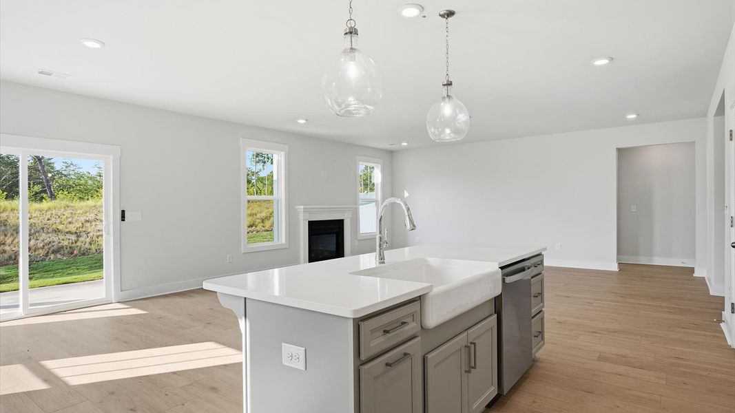 Vibrant kitchen layout with a center island, refined finishes, and open-concept flow at the Wells Crossing community