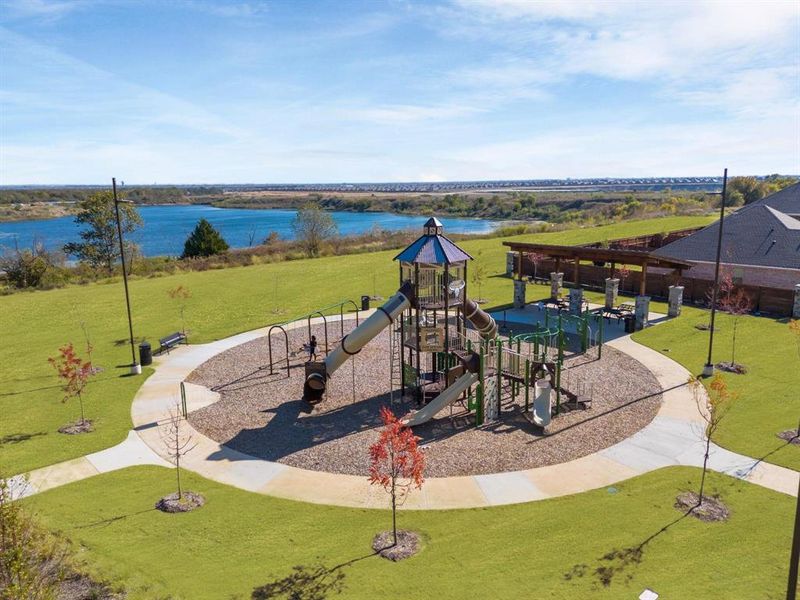 Communal playground with a yard and a water view