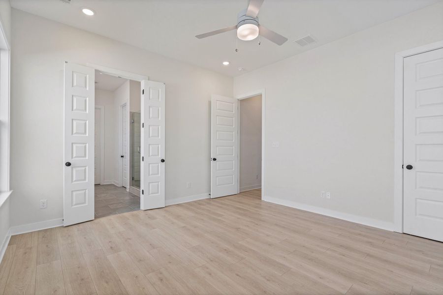Wood-finish flooring, recessed lighting, and a ceiling fan with integrated light