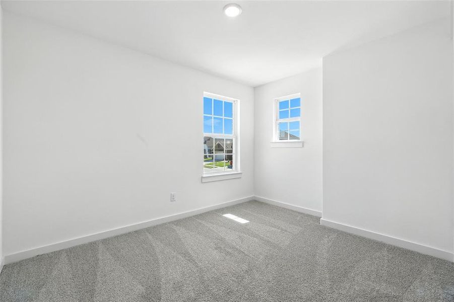 Carpeted empty room with baseboards Carpeted empty room with baseboards