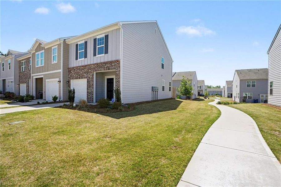 Front exterior of a new home in , Locust Grove, GA, highlighting curb appeal (Image 22).