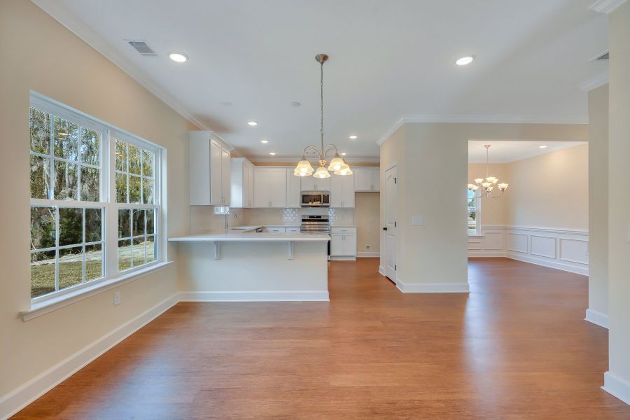 View from family room to breakfast area, dining room, and kitchen - Nantucket plan built by Ernest Homes - Customer selections View from family room to breakfast area, dining room, and kitchen - Nantucket plan built by Ernest Homes - Customer selections