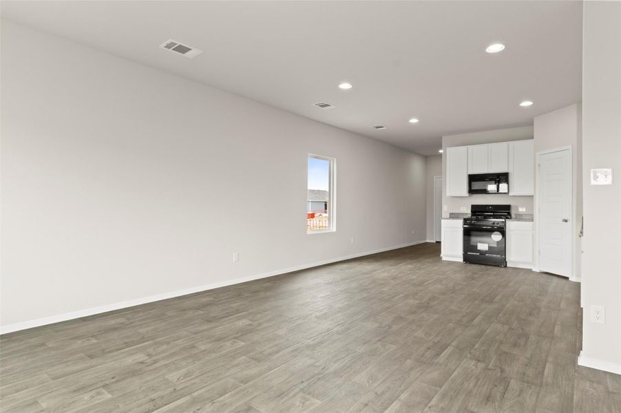 Unfurnished living room with recessed lighting and light wood-style flooring