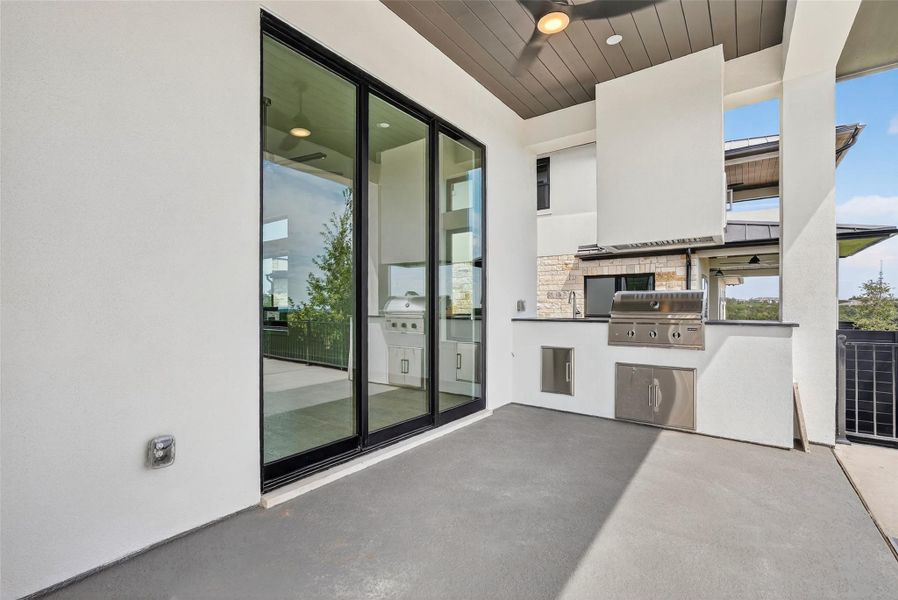 Exterior details and patio area of a home in Milky Way at River Place, Austin (Image 25).