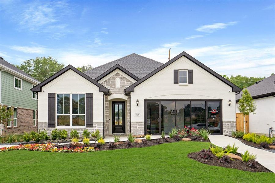 Front exterior of a new home in Devonshire, Forney, TX, highlighting curb appeal (Image 26). Front exterior of a new home in Devonshire, Forney, TX, highlighting curb appeal (Image 26).