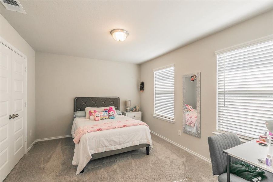 Bedroom featuring carpet and a closet