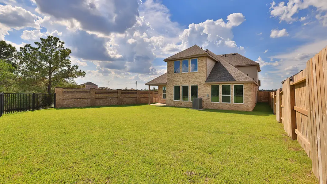 Exterior details and patio area of a home in Grand Magnolia, Magnolia (Image 3).