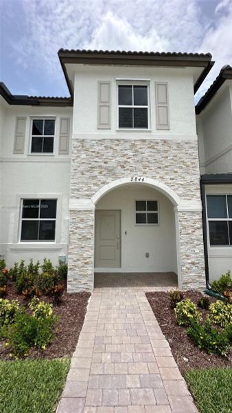 Front exterior of a new home in , Homestead, FL, highlighting curb appeal (Image 1). Front exterior of a new home in , Homestead, FL, highlighting curb appeal (Image 1).