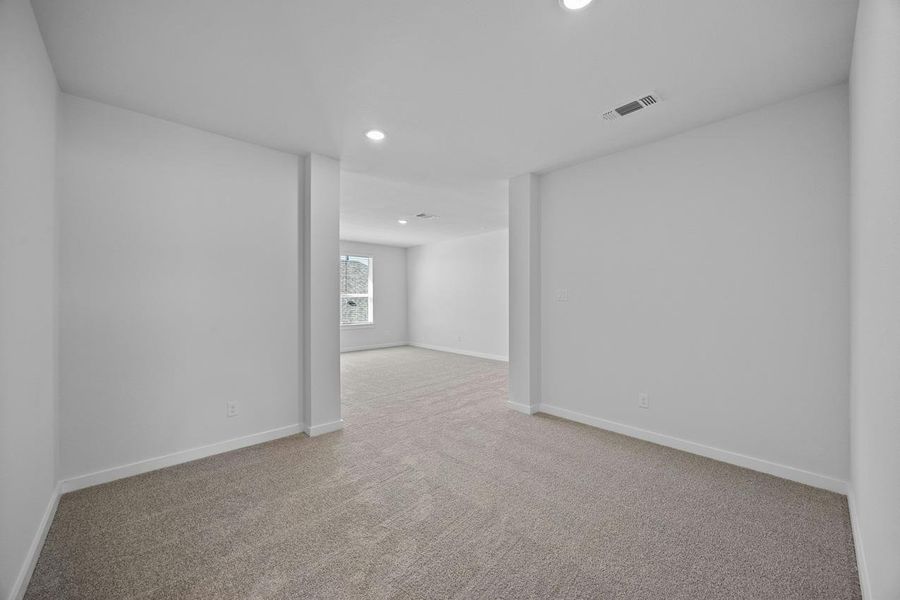 Carpeted empty room with recessed lighting and baseboards Carpeted empty room with recessed lighting and baseboards