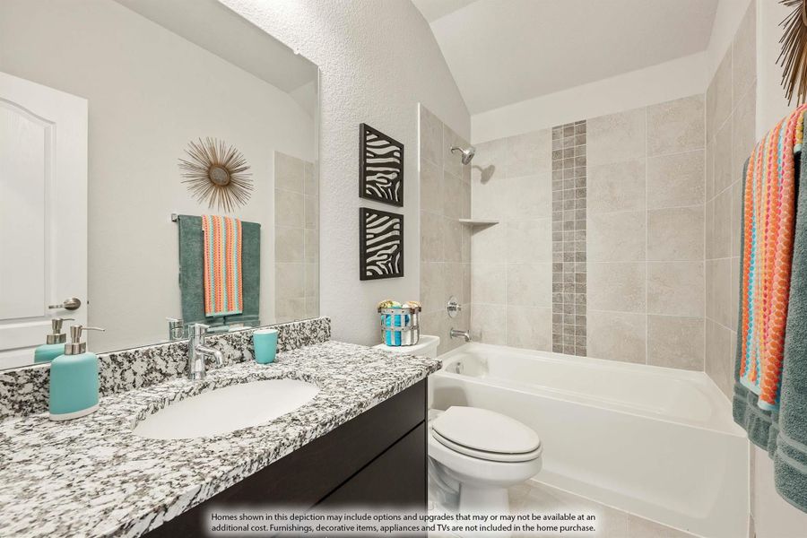 Bathroom with granite countertop vanity, soaking tub, tiled shower surround, and vaulted ceiling Bathroom with granite countertop vanity, soaking tub, tiled shower surround, and vaulted ceiling