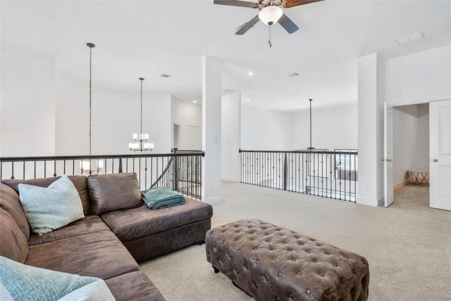Spacious, sunlit upstairs game room featuring a versatile, open layout perfect for a pool table, entertainment center, or dedicated playroom. This flexible space is ideal for family movie nights, hobbies, or indoor recreation.