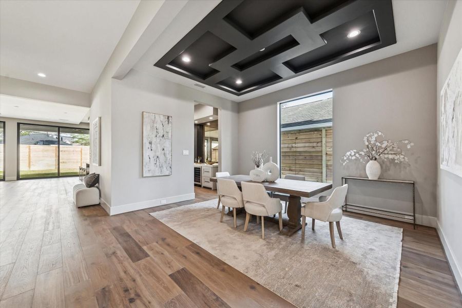 The large dining room is filled with natural light and showcases contemporary ceiling details that add style and sophistication. It offers access to the butler’s pantry/bar area and the kitchen, making it ideal for both entertaining and everyday living.