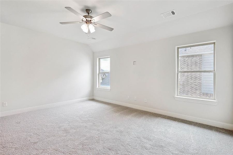 Empty room with carpet floors and ceiling fan