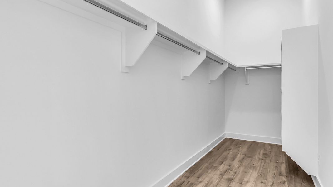Large walk-in closet with built in shelving (Representative of completed home)