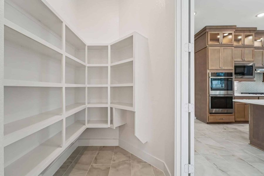 Representative furnished interior of a home built from the Lauren by Chesmar Homes in University Heights, Round Rock (Image 6).