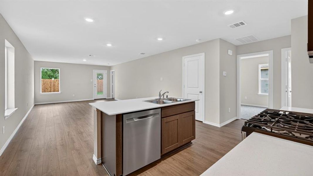 Open-concept area featuring wood-finish flooring, recessed lighting, and light-toned walls