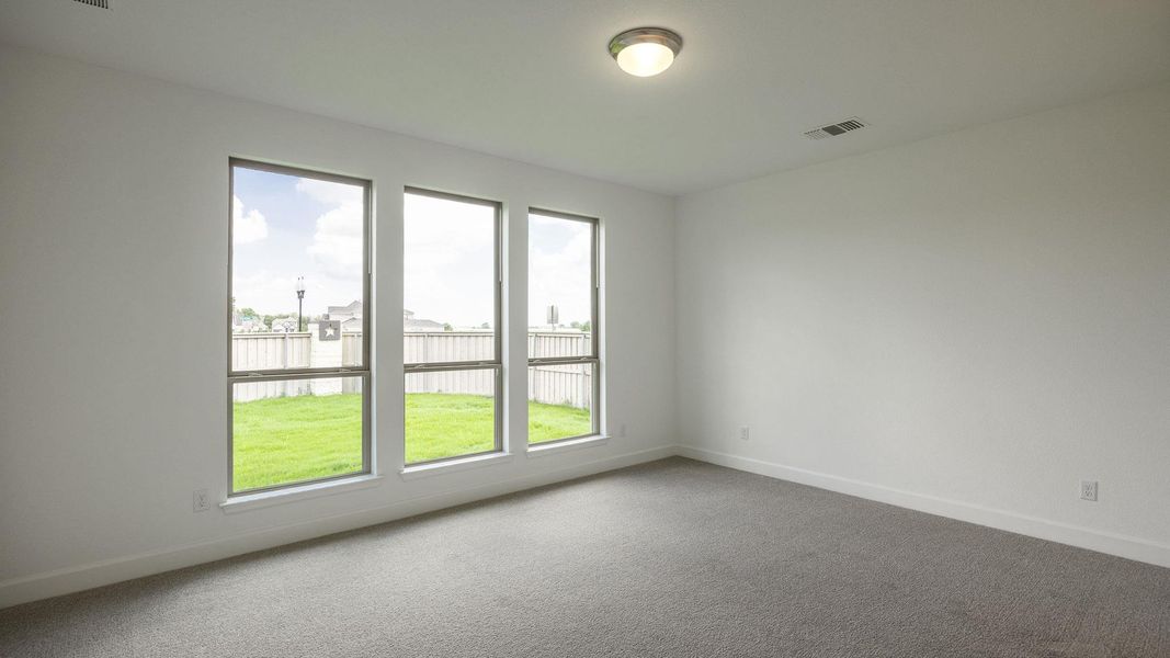 Unfurnished room with carpet flooring and baseboards Unfurnished room with carpet flooring and baseboards