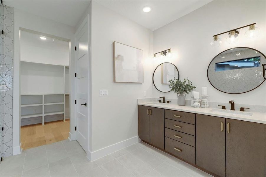 Dual vanity with custom cabinets and quartz countertops.