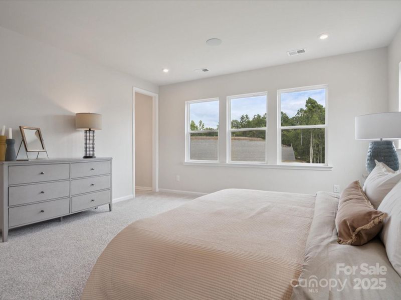 Primary Suite with Wall of Windows and 9' Ceilings. *Model Photos | Actual Finishes, Structural Selections, and Orientation May Vary. Primary Suite with Wall of Windows and 9' Ceilings. *Model Photos | Actual Finishes, Structural Selections, and Orientation May Vary.