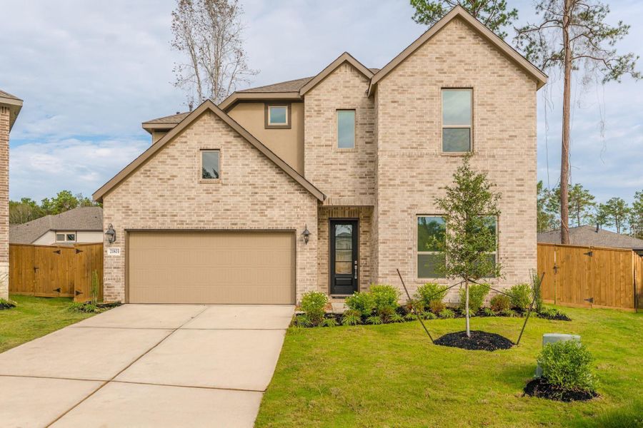 Front exterior of a new home in The Highlands, Porter Heights, TX, highlighting curb appeal (Image 1). Front exterior of a new home in The Highlands, Porter Heights, TX, highlighting curb appeal (Image 1).