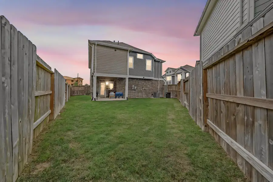 Exterior details and patio area of a home in The Groves, Humble (Image 3).