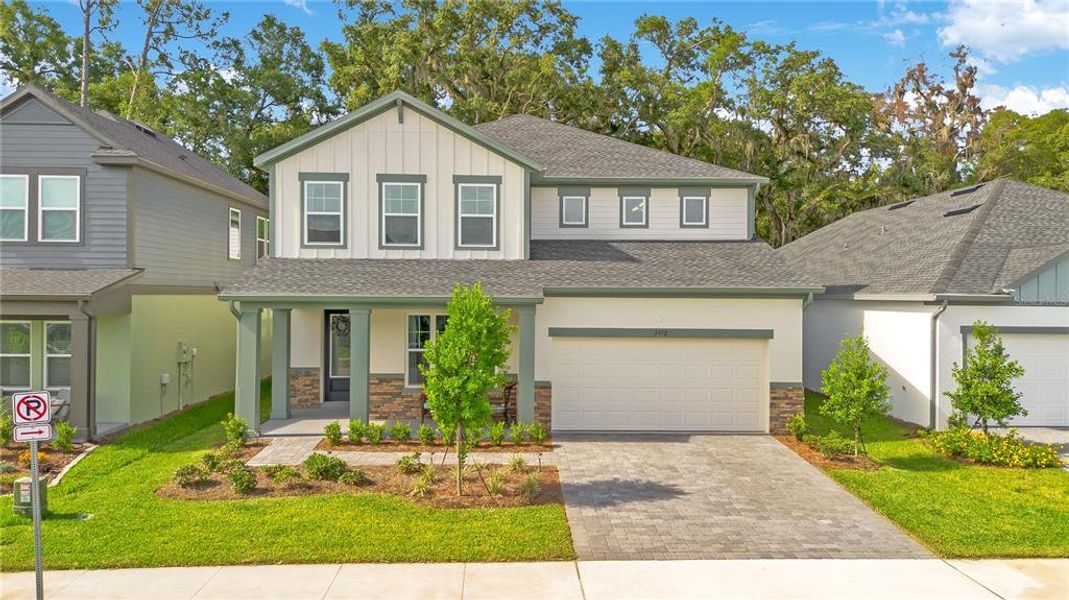 Front exterior of a new home in Oakfield at Mount Dora Village Series, Mount Dora, FL, highlighting curb appeal (Image 24).