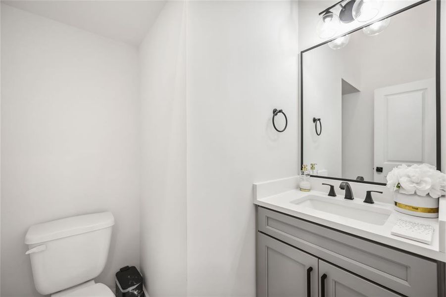 Powder room right off dining area.