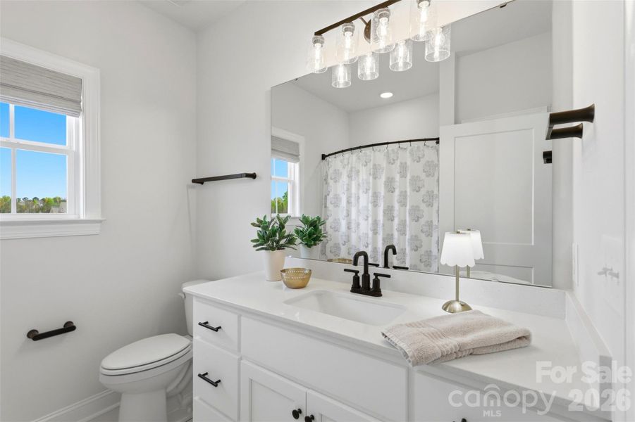 Clean and stylish main level bathroom featuring modern fixtures and a bright, refreshing design.