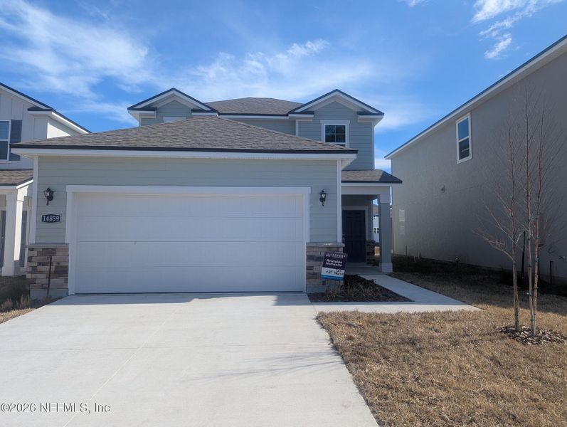 Front exterior of a new home in The Landings at Pecan Park, Jacksonville, FL, highlighting curb appeal (Image 1). Front exterior of a new home in The Landings at Pecan Park, Jacksonville, FL, highlighting curb appeal (Image 1).