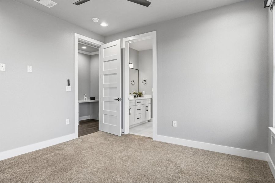 Unfurnished bedroom featuring light colored carpet, a ceiling fan, recessed lighting, and ensuite bath