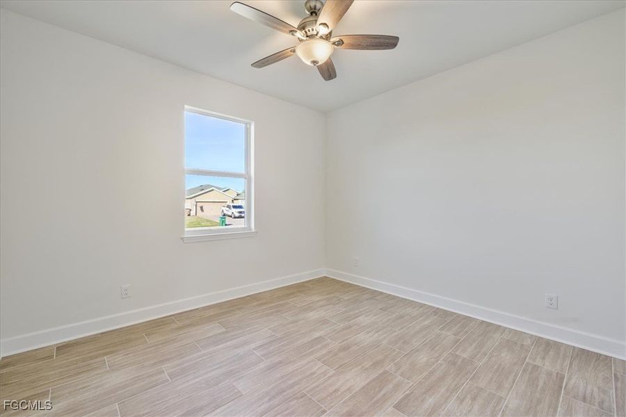 Unfurnished room featuring wood finish floors and ceiling fan