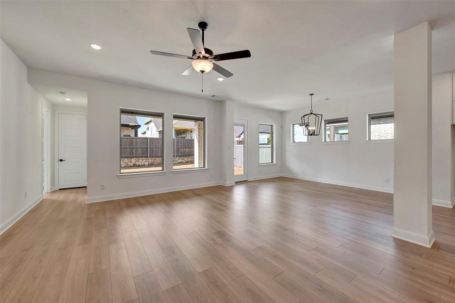 Unfurnished living room featuring ceiling fan, light wood-type flooring, recessed lighting, and healthy amount of natural light