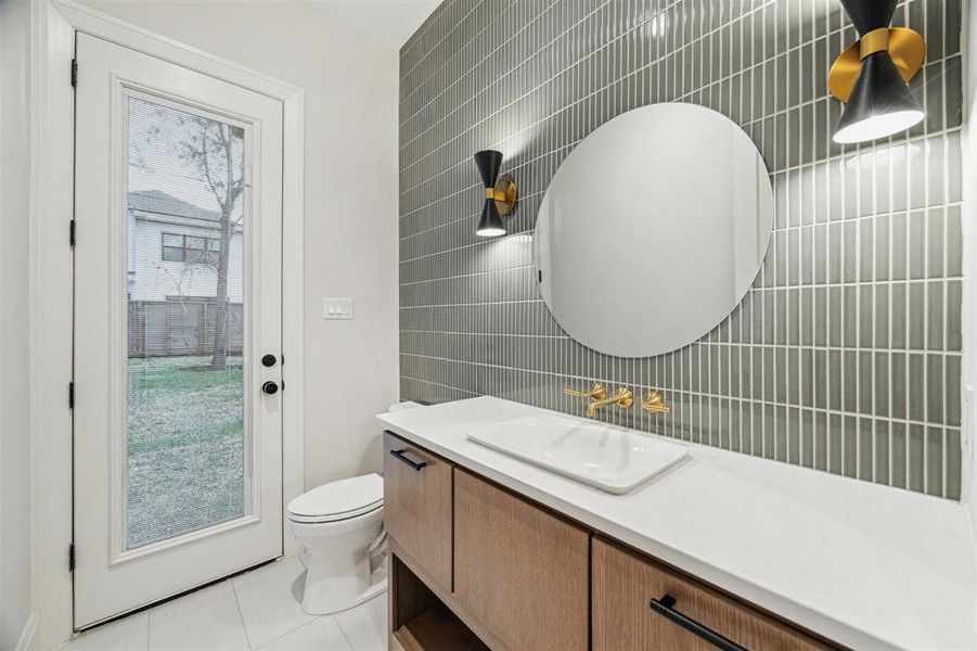 Downstairs powder bath with backyard access to serve as pool bath