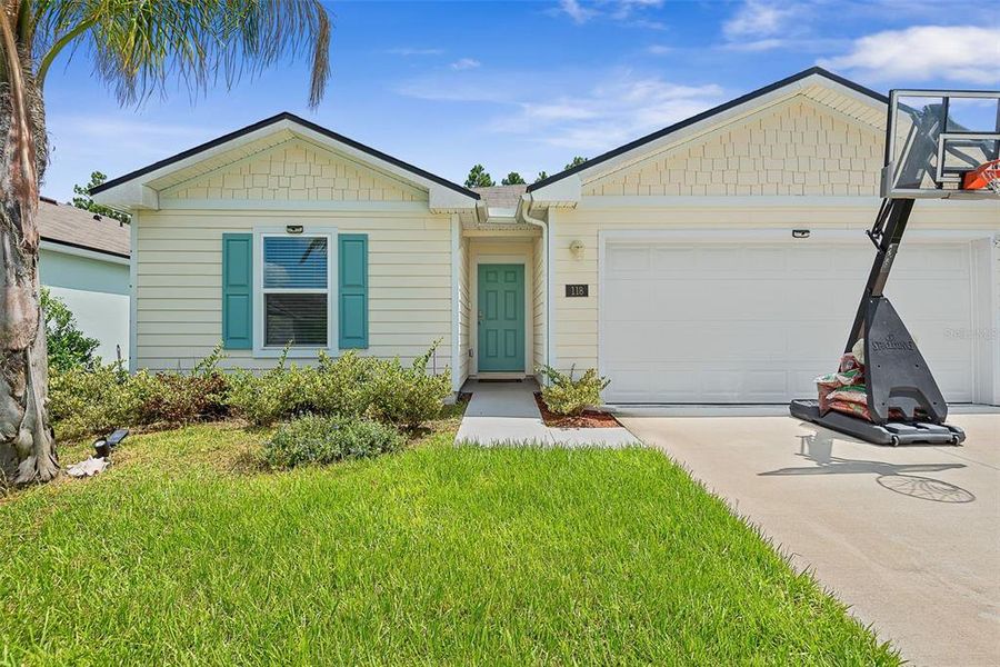 Front exterior of a new home in Sawmill Branch, Palm Coast, FL, highlighting curb appeal (Image 2).