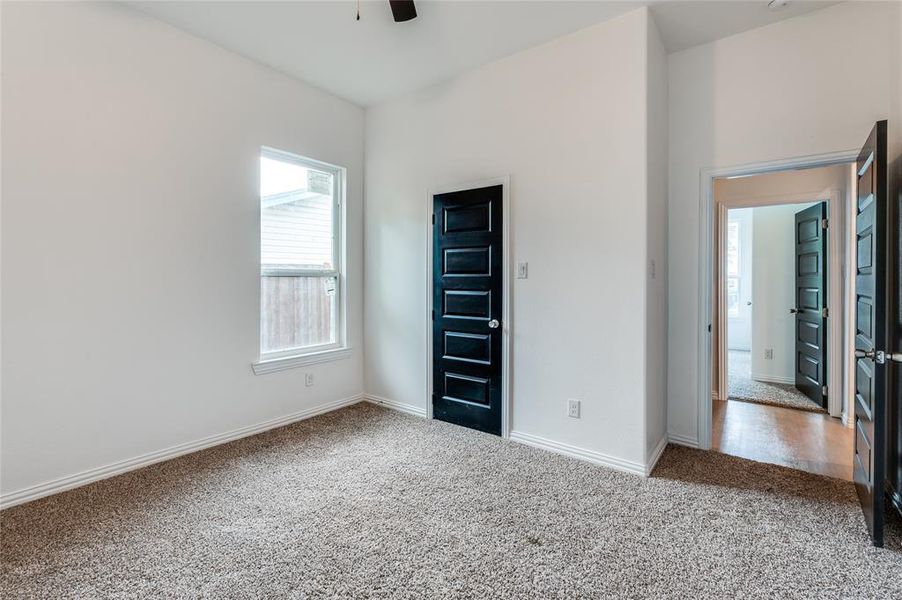 Unfurnished bedroom featuring ceiling fan and carpet floors