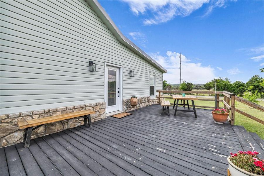 View of wooden deck and front door