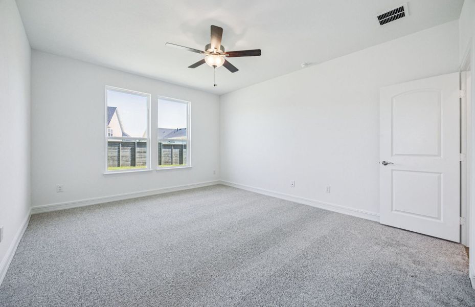 Elegant owner's suite with large windows *real home pictured