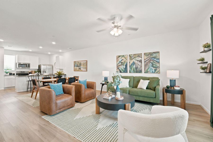 An open floorplan seamlessly connects the living space to the dining area and kitchen beyond.