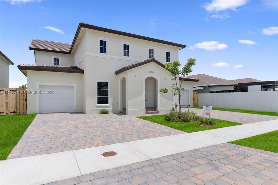 Front exterior of a new home in , Homestead, FL, highlighting curb appeal (Image 1). Front exterior of a new home in , Homestead, FL, highlighting curb appeal (Image 1).