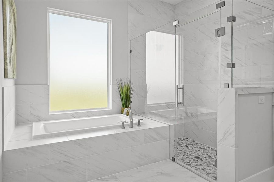 Wash away the stress of the day in this large, jetted garden tub and frameless glass shower. The shower boasts floor-to-ceiling tiling and a river rock flooring accent.