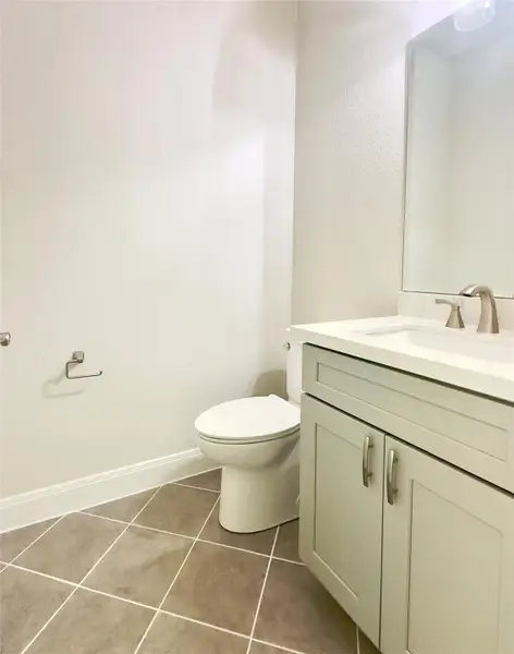 Half bathroom featuring vanity and tile patterned floors Half bathroom featuring vanity and tile patterned floors