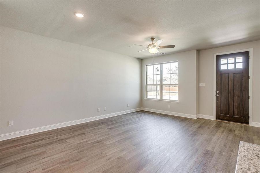 Entryway with ceiling fan and light wood-type flooring