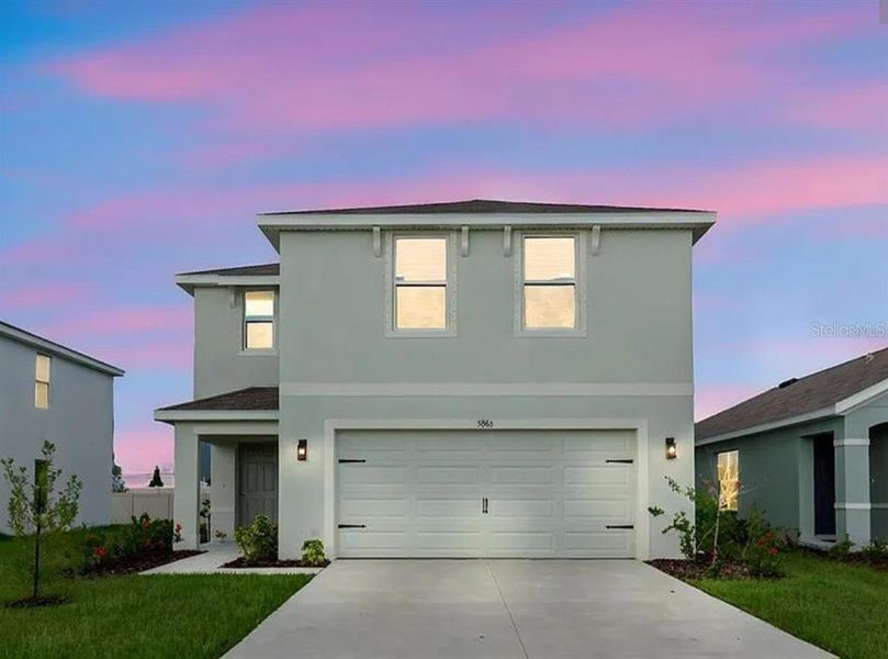 Front exterior of a new home in Silverstone North, Palmetto, FL, highlighting curb appeal (Image 1).