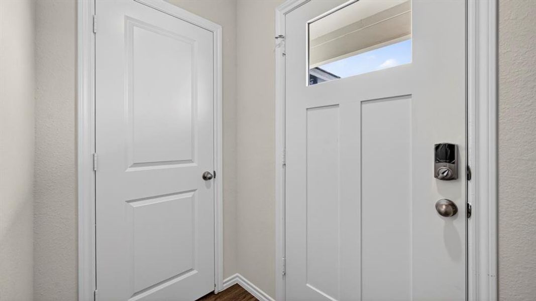White craftsman-style door featuring clear glass transom and digital entry system