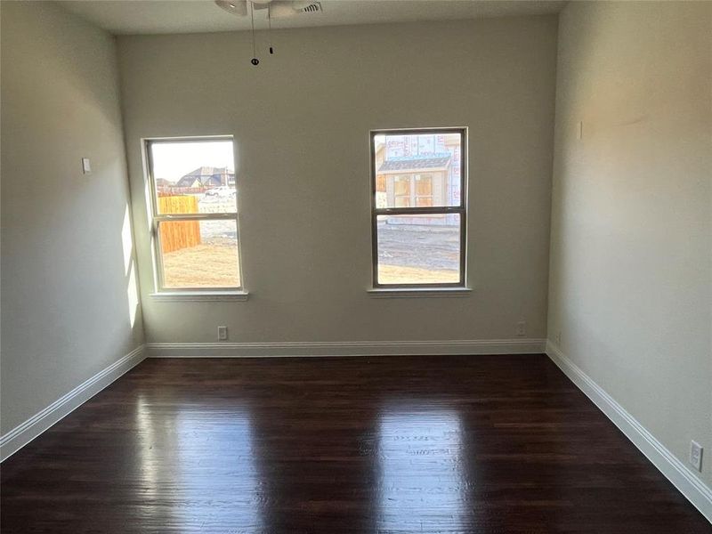 Unfurnished room featuring dark wood-type flooring