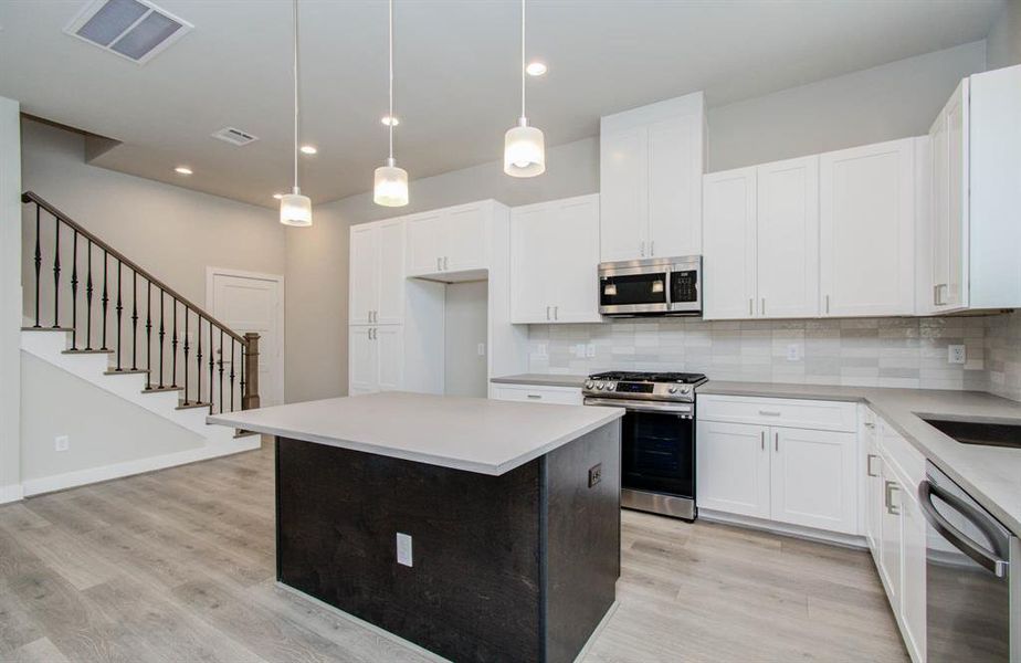 Gorgeous quartz countertops. (Transitional finish shown).