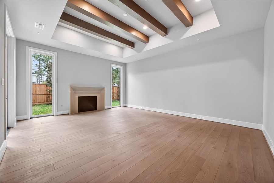 Enter the primary suite, which is adorned with wood ceiling beams, a fireplace, and a door leading to the patio, providing for a luxurious retreat. Enter the primary suite, which is adorned with wood ceiling beams, a fireplace, and a door leading to the patio, providing for a luxurious retreat.